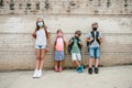 Kids looking at camera waiting outside school during Coronavirus pandemic Royalty Free Stock Photo