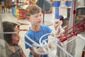 Kids looking through glass at a science exhibit, close up