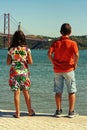 Kids looking at river Tejo on a beautiful sunny afternoon.