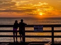 Kids looking at sunrise from the pier