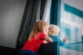 Kids looking at the window while staying home, girls being homesick Royalty Free Stock Photo