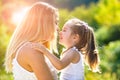 Kids love. Lifestyle portrait mom and daughter in happy mood at the outside. Happy loving family - mother and daughter. Royalty Free Stock Photo