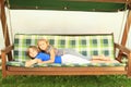 Kids lying on a garden swing Royalty Free Stock Photo