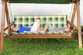 Kids lying on a garden swing Royalty Free Stock Photo