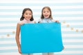 Kids make advertisement. advertising your product. smiling little girls kids hold blue advertisement poster for copy Royalty Free Stock Photo