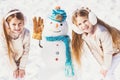 Kids make Snowman on white snow background. Theme Christmas holidays winter new year.