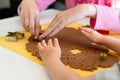 Kids making gingerbread cookies with various Christmas cookie cutters. Gingerbread dough. Family Christmas moments Royalty Free Stock Photo
