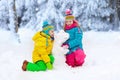 Kids making winter snowman. Children play in snow Royalty Free Stock Photo