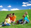 Kids in a Meadow with Laptops Royalty Free Stock Photo