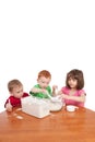 Kids measuring and mixing flour in kitchen bowl