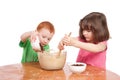 Kids mixing and pouring cake ingredients Royalty Free Stock Photo