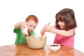 Kids mixing and pouring cake ingredients