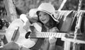Kids music and songs. Child musician playing the guitar like a rockstar. Happy cute teen girl swinging and having fun Royalty Free Stock Photo
