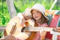 Kids music and songs. Little child playing guitar. Fashion kid girl. Kids music guitar school. Smiling child playing Royalty Free Stock Photo