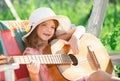 Kids music and songs. Little child playing guitar. Fashion kid girl. Kids music guitar school. Smiling child playing Royalty Free Stock Photo