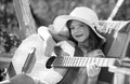 Kids music and songs. Little child playing guitar. Fashion kid girl. Kids music guitar school. Smiling child playing Royalty Free Stock Photo