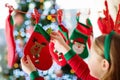 Kids opening Christmas presents. Child searching for candy and gifts in advent calendar on winter morning. Decorated Christmas Royalty Free Stock Photo