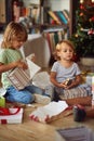 Kids opening Xmas presents. Children under Christmas tree with gift boxes Royalty Free Stock Photo