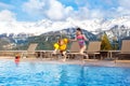 Kids in outdoor swimming pool of Alpine resort Royalty Free Stock Photo