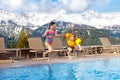 Kids in outdoor swimming pool of Alpine resort Royalty Free Stock Photo