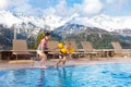 Kids in outdoor swimming pool of Alpine resort Royalty Free Stock Photo