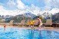 Kids in outdoor swimming pool of Alpine resort Royalty Free Stock Photo