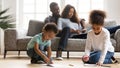 Kids painting in color books relaxing with parents at home Royalty Free Stock Photo