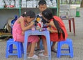 Kids are painting doll on the street in Hanoi