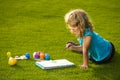 Kids painting drawing art. Child boy enjoying art and craft drawing in backyard or spring park. Children drawing draw