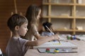 Kids painting pictures on canvas sit at table in art-studio Royalty Free Stock Photo