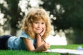 Kids painting in spring nature. Kids painting with paints color and brush in park outdoor. Royalty Free Stock Photo