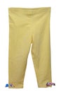 Kids pants isolated. Close-up of a stylish fashionable yellow corduroy trousers with ribbon bows for the little girl. Clipping