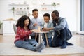 Kids and parents building block tower on coffee table Royalty Free Stock Photo