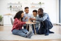 Kids and parents building block tower on coffee table Royalty Free Stock Photo