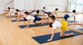 Kids and parents doing bird dog exercise in gym Royalty Free Stock Photo