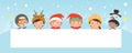 Kids peeping behind placard, children and greeting Christmas and New Year card, boy and girl in Christmas costume characters Royalty Free Stock Photo