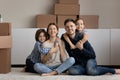 Kids piggyback parents look at camera relaxing on relocation day