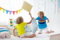 Kids pillow fight. Bedroom for two children Royalty Free Stock Photo