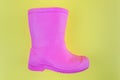 Kids pink rubber boots EVA on a yellow background Royalty Free Stock Photo