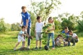 Kids planting trees with volunteers Royalty Free Stock Photo