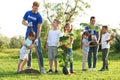 Kids planting trees with volunteers Royalty Free Stock Photo