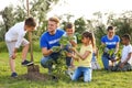 Kids planting trees with volunteers Royalty Free Stock Photo