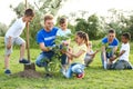 Kids planting trees with volunteers Royalty Free Stock Photo