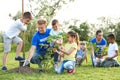 Kids planting trees with volunteers Royalty Free Stock Photo