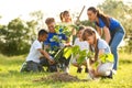 Kids planting trees with volunteers Royalty Free Stock Photo