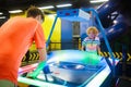 Kids play air hockey. Fun arcade games Royalty Free Stock Photo