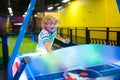 Kids play air hockey. Fun arcade games Royalty Free Stock Photo