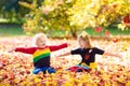 Kids play in autumn park. Children in fall. Royalty Free Stock Photo