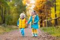 Kids play in autumn park. Children in fall. Royalty Free Stock Photo