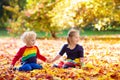 Kids play in autumn park. Children in fall Royalty Free Stock Photo